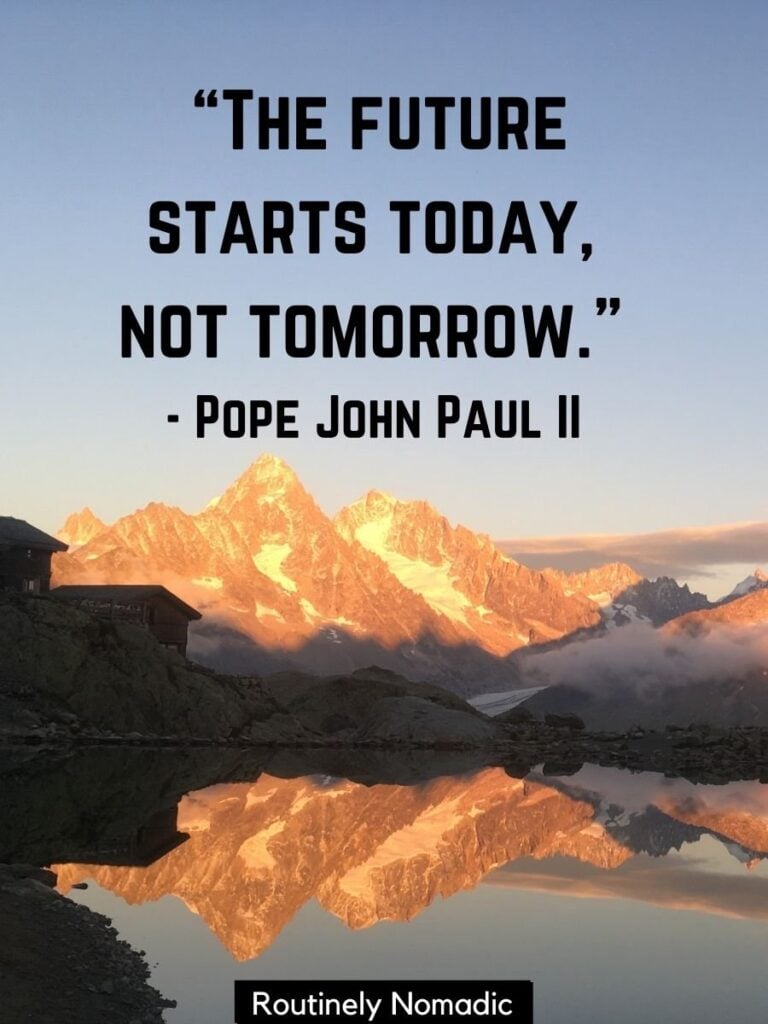 Mountains reflected in lake with positive quotes for today by Pope John Paul II